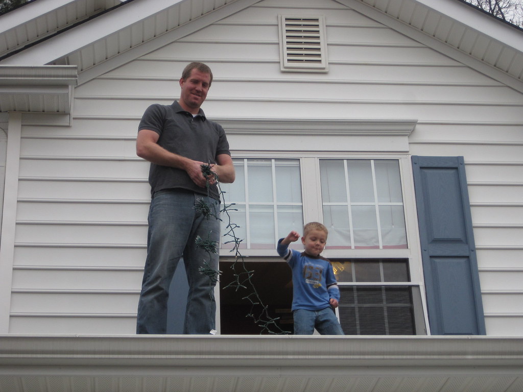 Taking down the Christmas lights Waving from up high Shannon Smith
