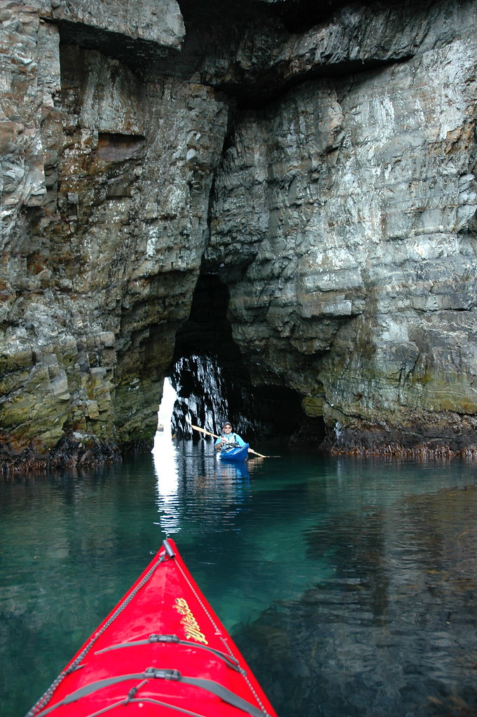 Entering Arch Deluxe Paddling into sea arch in Cape Broyle… kayak
