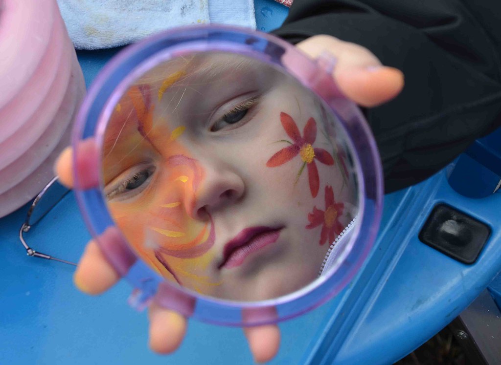 Haley Lemieux checks out her face paint job in a mirror. P… Flickr