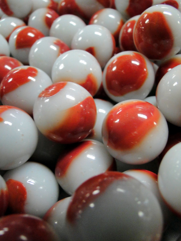 Marble Anyone? Some red and white marbles out of the many … Flickr