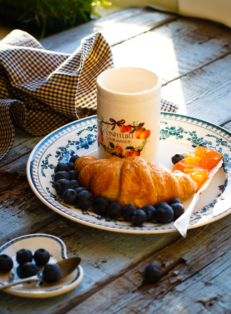 Country breakfast with croissant, apricot jam and fresh be
