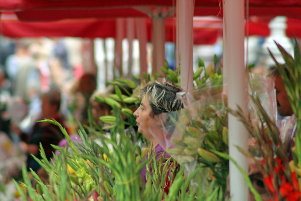 Flower Shop A woman sells fresh flowers at an open market … Flickr