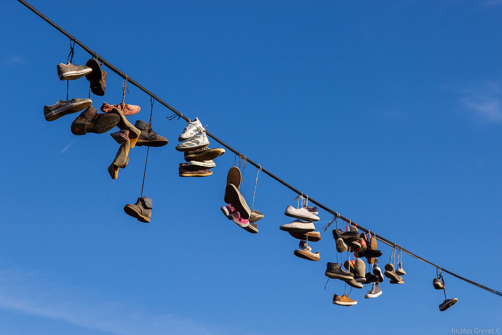 Shoes on a Wire Various shoes are hanging on a wire next