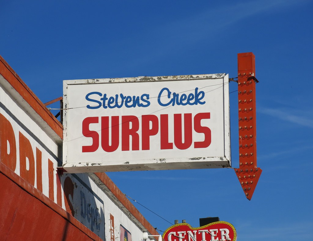 Stevens Creek Surplus Sign with Flashing Red Arrow Flickr
