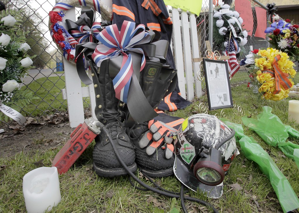 Makeshift memorial A miner's boots, helmet and gloves appe… Flickr