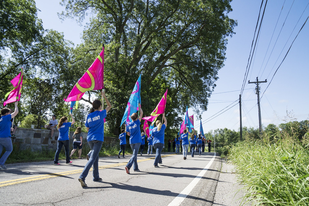 Girls holdingcolorful flags in the parade at the Viola Valley