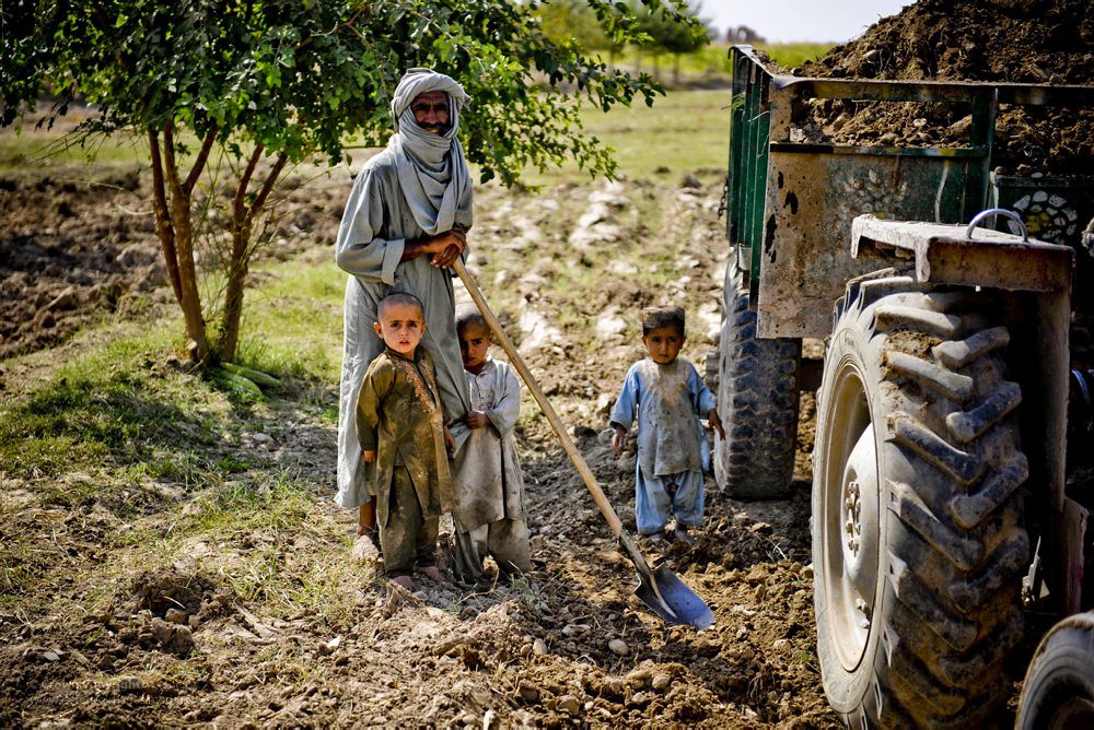 An Afghan Farmer and his Family Stand Beside a Tractor in … Flickr
