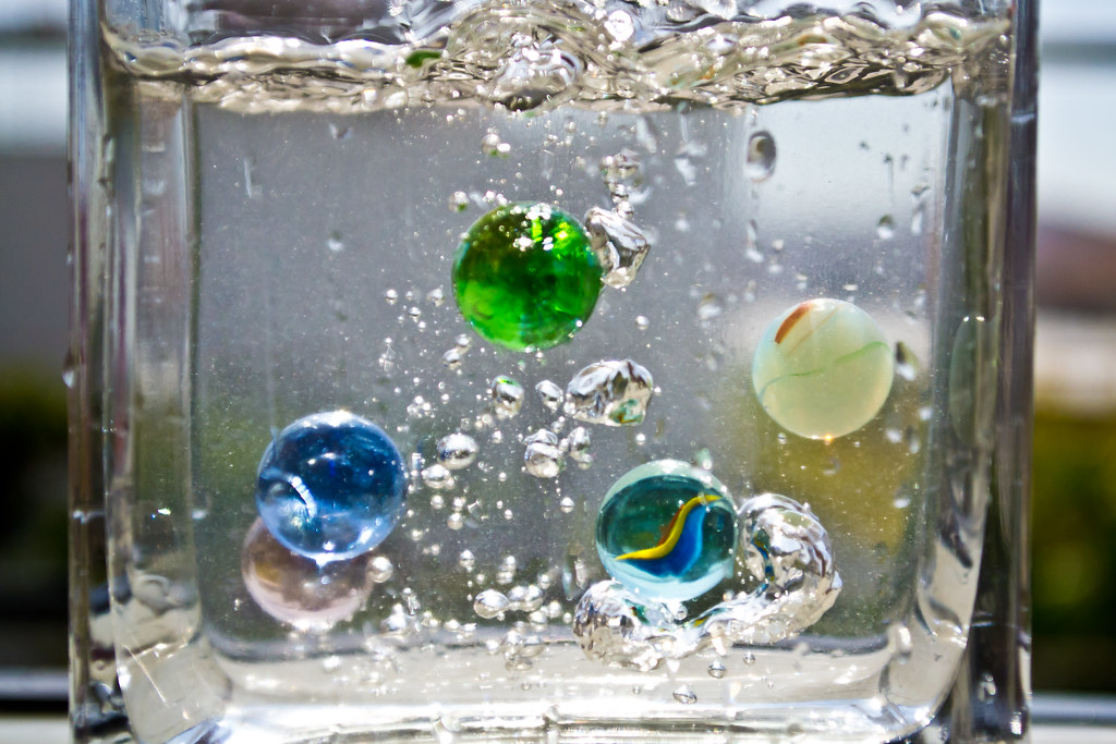 Marbles in a glass of water Javier Morales Flickr