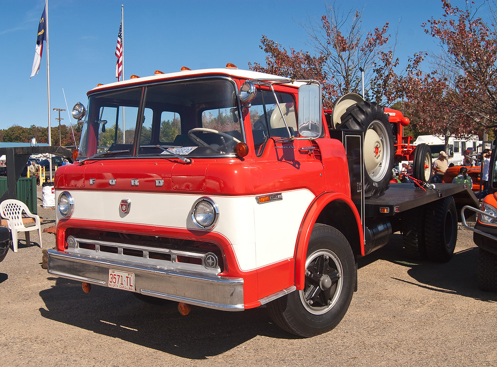Ford CSeries cabover truck with a restored Ford tractor on the bed a