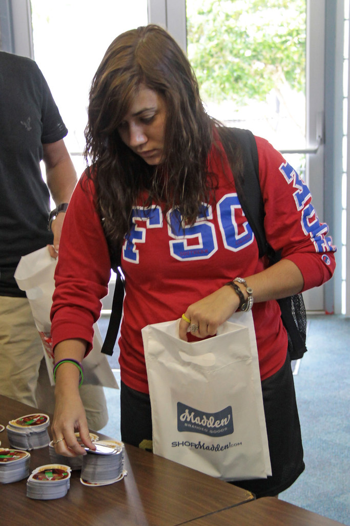 BusUnitedWay_10 Students stuffing gift packets for Red Rib… Flickr