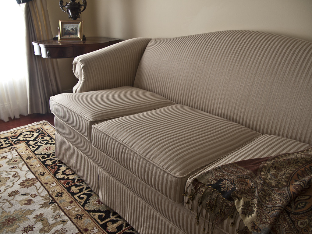 Upholstered Couch Upholstered couch in room with area rug … Flickr