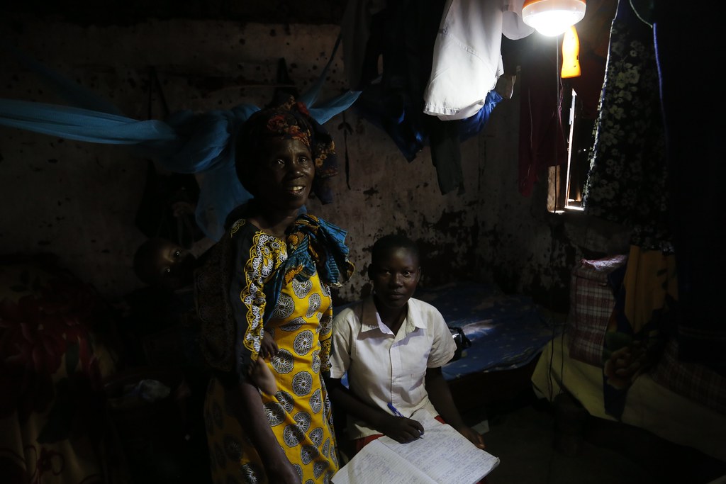 Hadija and her daughter, using an Ensol solar lighting kit… Flickr