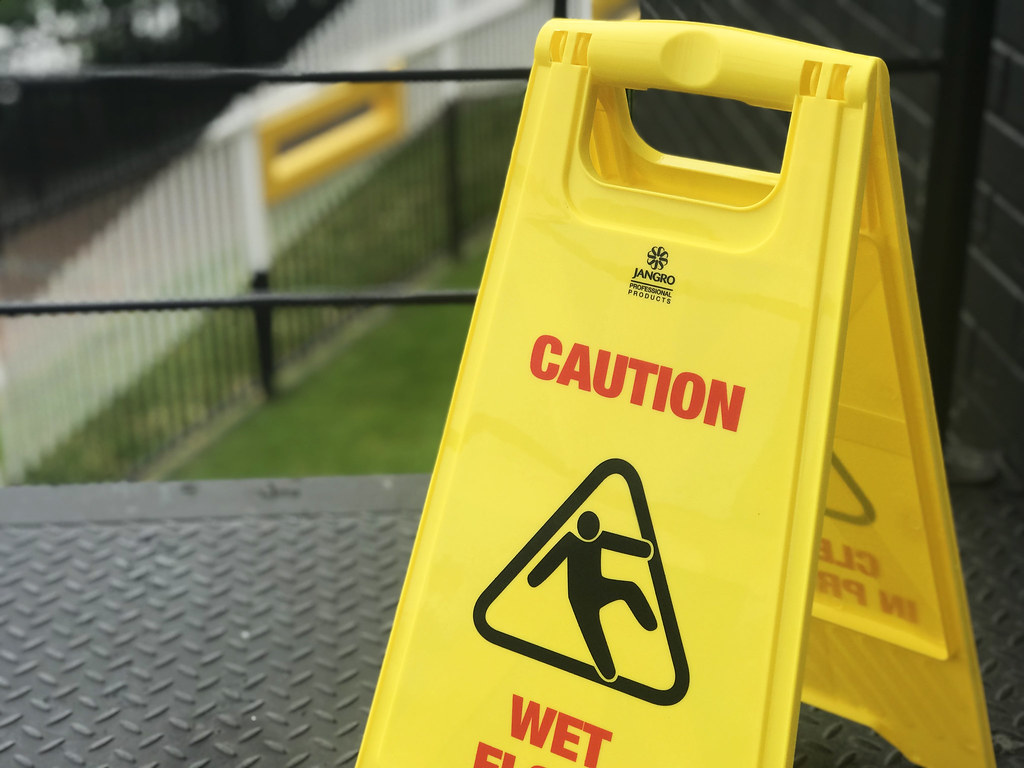 Stock photo image of a yellow 'caution wet floor' sign. Flickr