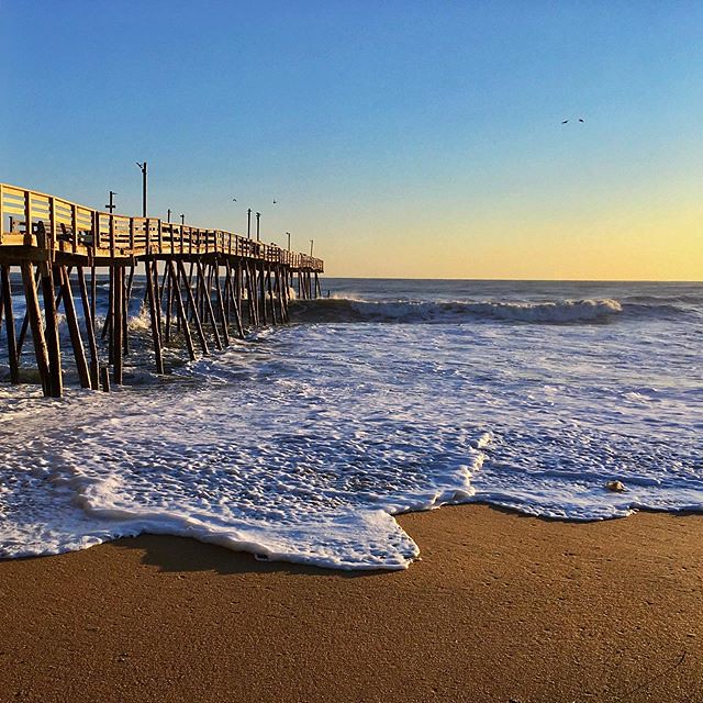 Sunrise lighting Avalon Pier in the Outer Banks, N.C. a photo on