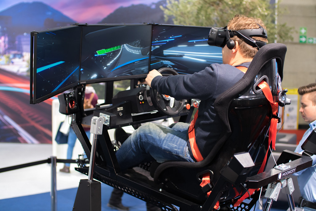 Full motion racing simulator with VR headset and multiple