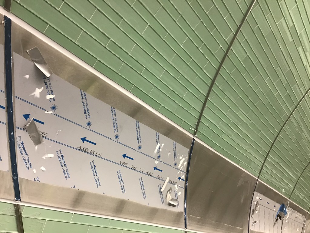 Grouting the glass tiles on the walls of one of the four w… Flickr