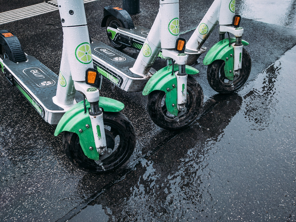 Lime electric scooters for rent parked on a wet sidewalk Flickr