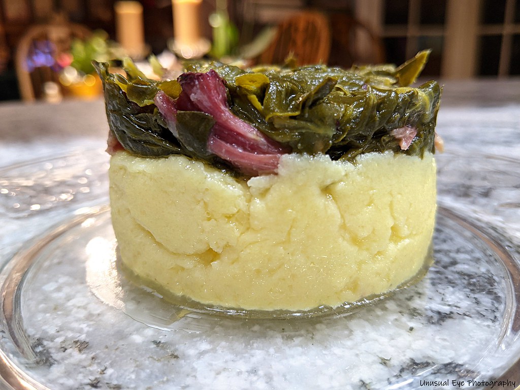 Collard greens served over cheesy polenta. Eat With Your Eyez Flickr