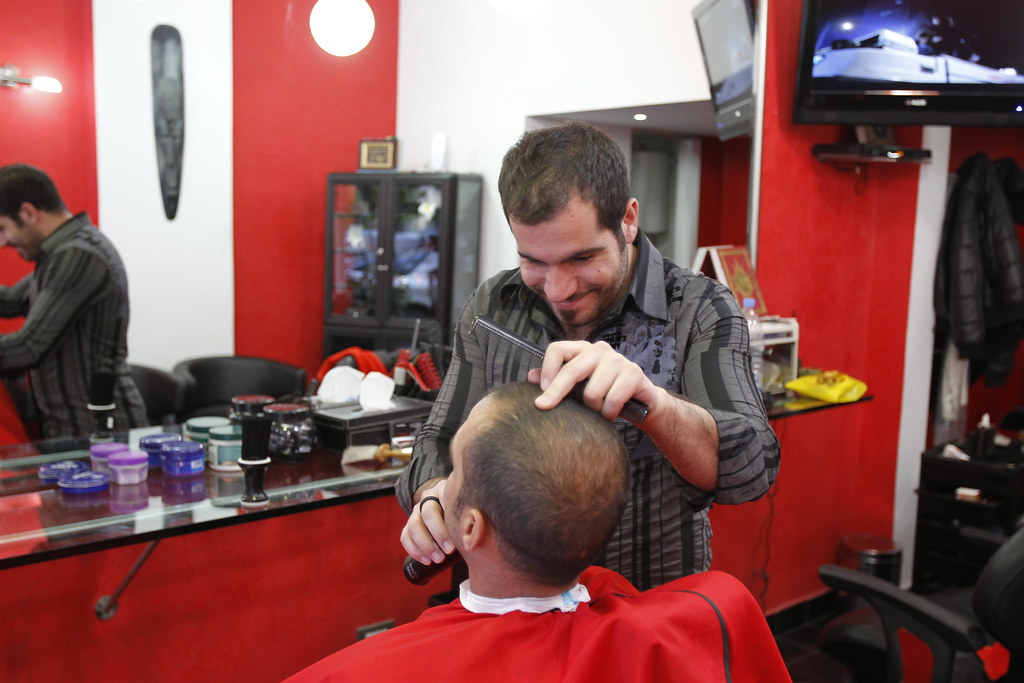 Lebanon A local hairdresser gives a customer a haircut. Cr… Flickr