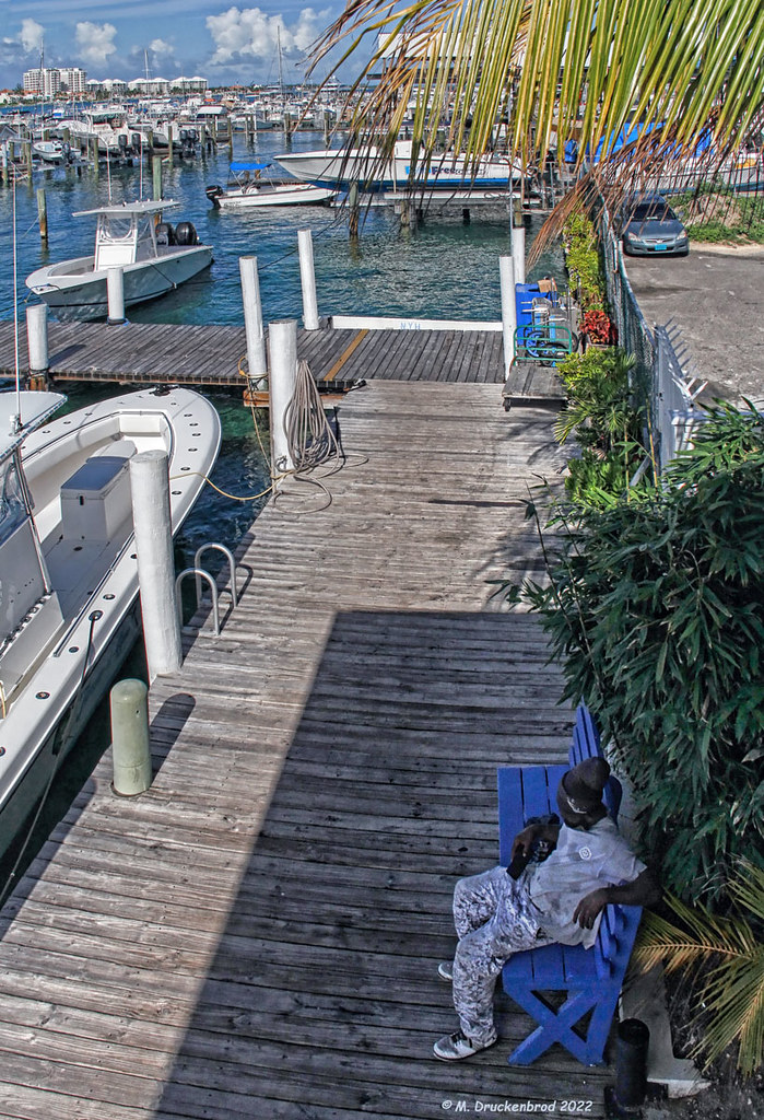 Relaxing in the Shade at the Nassau Yacht Haven on the walkway below