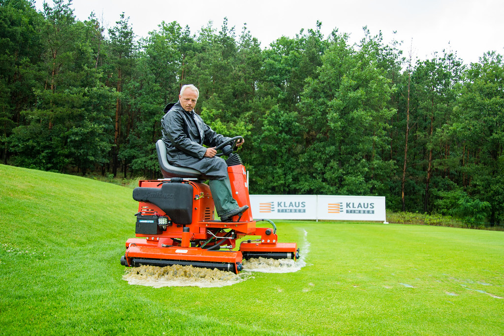 A greenkeeper irons the third tee box to remove water duri… Flickr