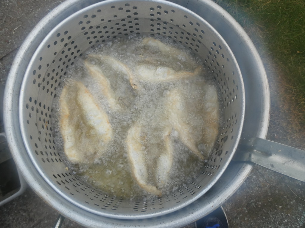 Deep frying fish outdoors after a long day at work Flickr