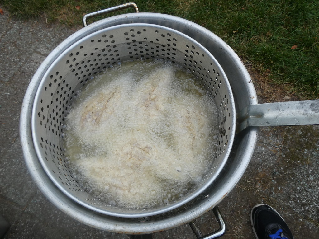 Deep frying fish outdoors after a long day at work Flickr