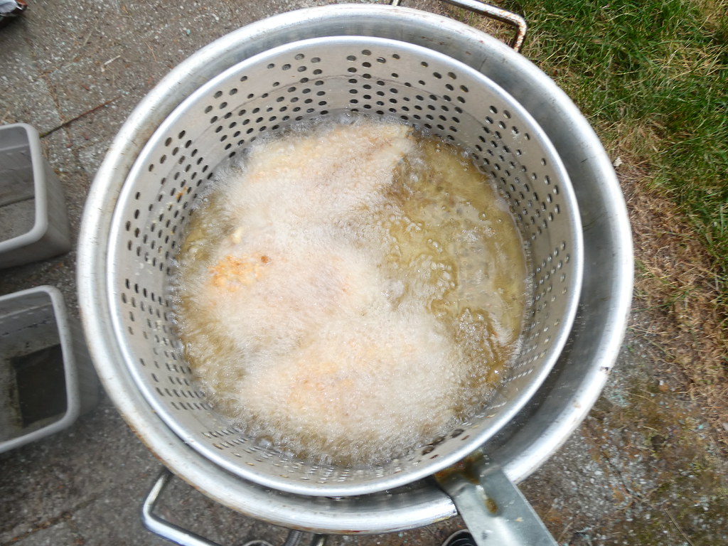 Deep frying fish outdoors after a long day at work Flickr