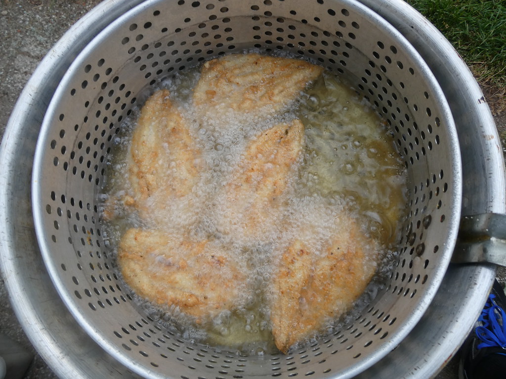 Deep frying fish outdoors after a long day at work Flickr