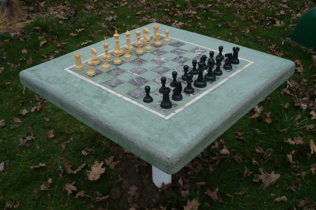 Chess army 011 Concrete chess table with chess pieces. Concrete