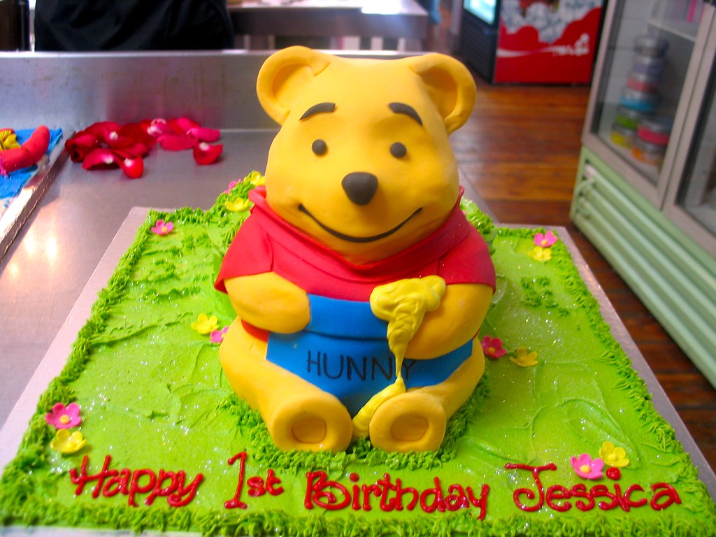 3D Winnie the Pooh shaped cake covered in fondant icing a photo on
