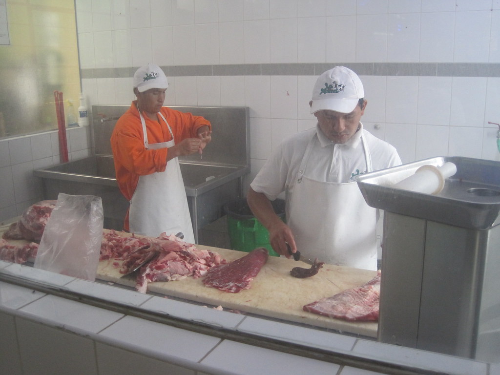 butchers butchers cutting and cleaning meat at la molina Luis