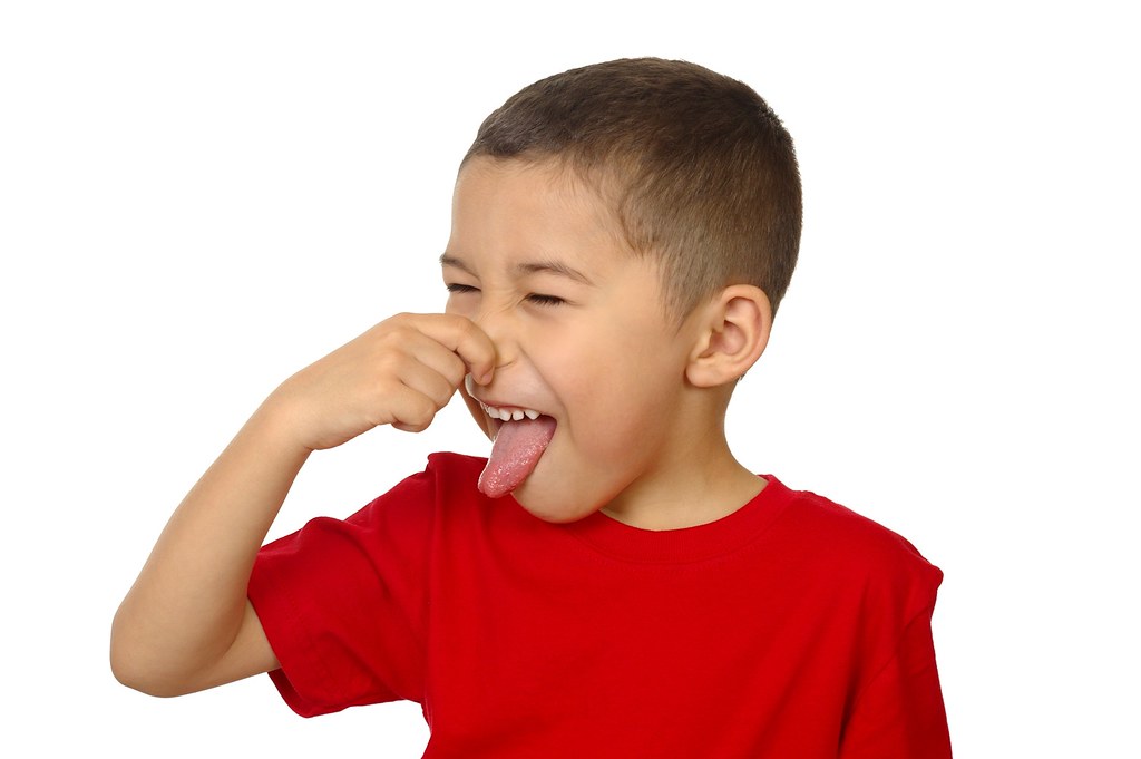 kid holding his nose from bad odor, isolated on white Flickr