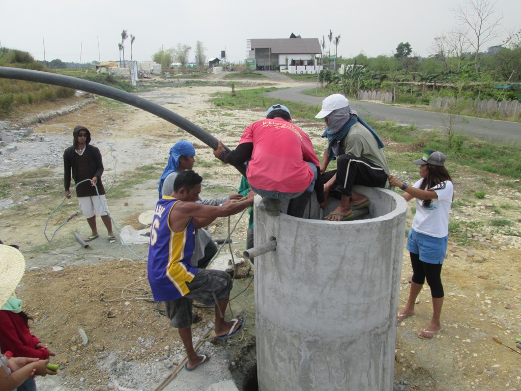 Placing the submersible water pump inside the deep well Flickr