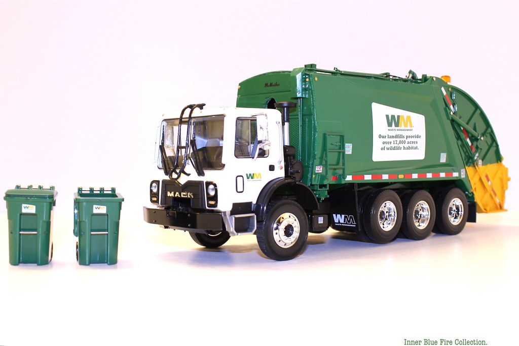 First Gear Waste Management rear load trash truck with bins. a photo