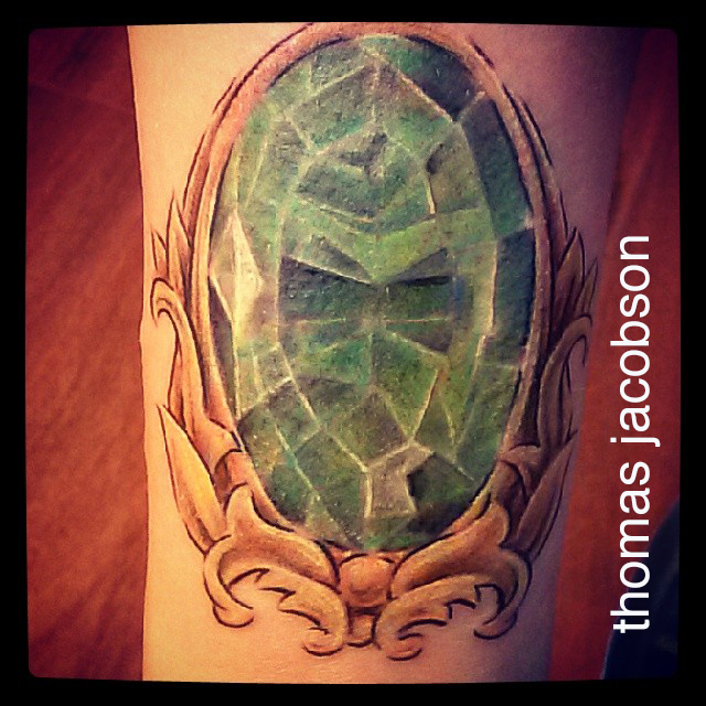 kryptonite green gemstone tattoo by thomas jacobson orlando florida a