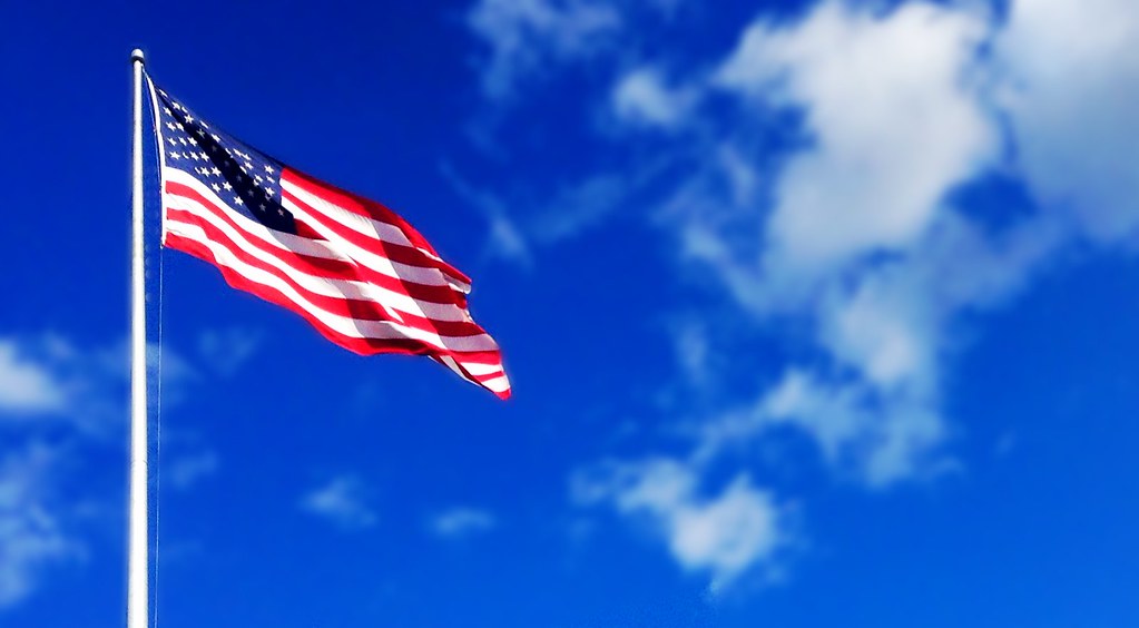 America Flag waving blue sky white puffy clouds American U… Flickr