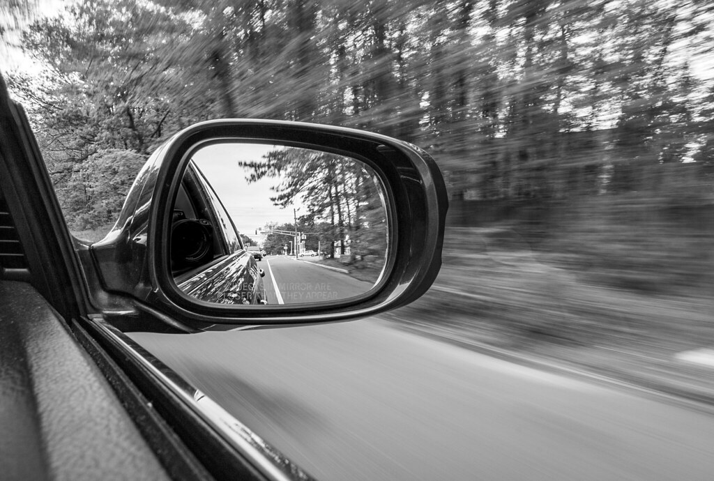 Car Mirror While sitting in the passenger seat, I held the… Flickr
