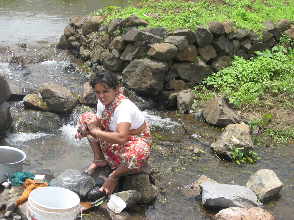 A women washing clothes near the stream India Water Portal Flickr
