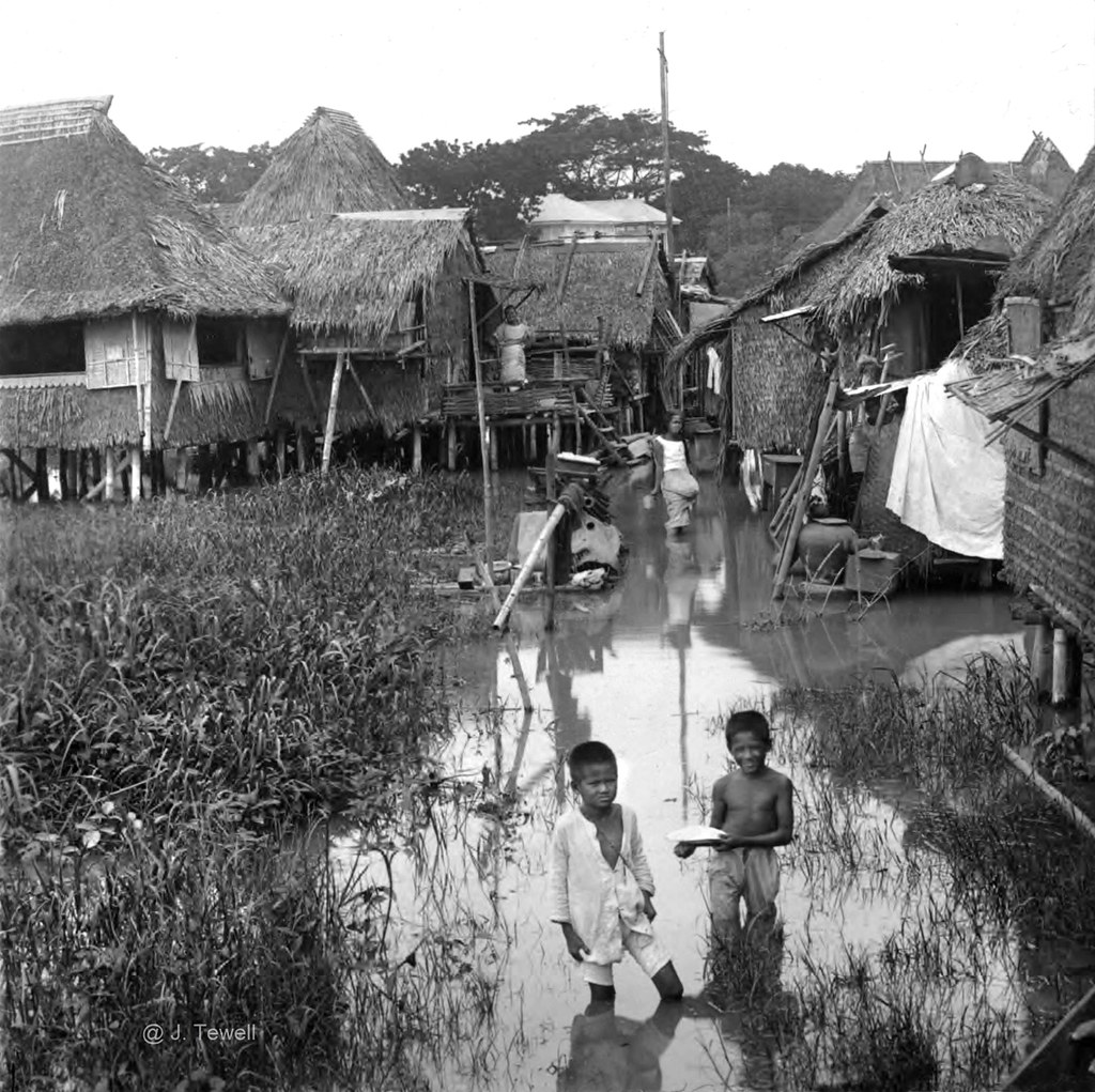 Flood tide in the outskirts of Manila among homes built on piles, early