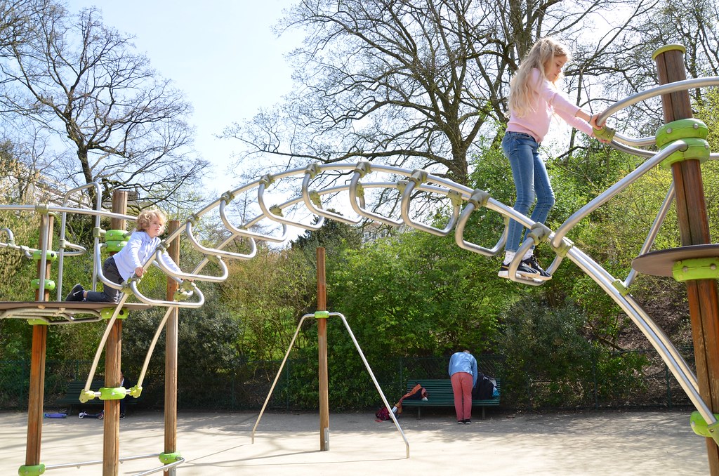 The Kids On The Monkey Bars In a playground in Parc des Bu… Flickr