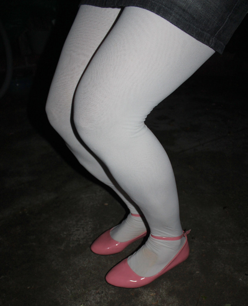 Female Legs With Pink Trendy Stripped Tights And Black Ballerina Flat