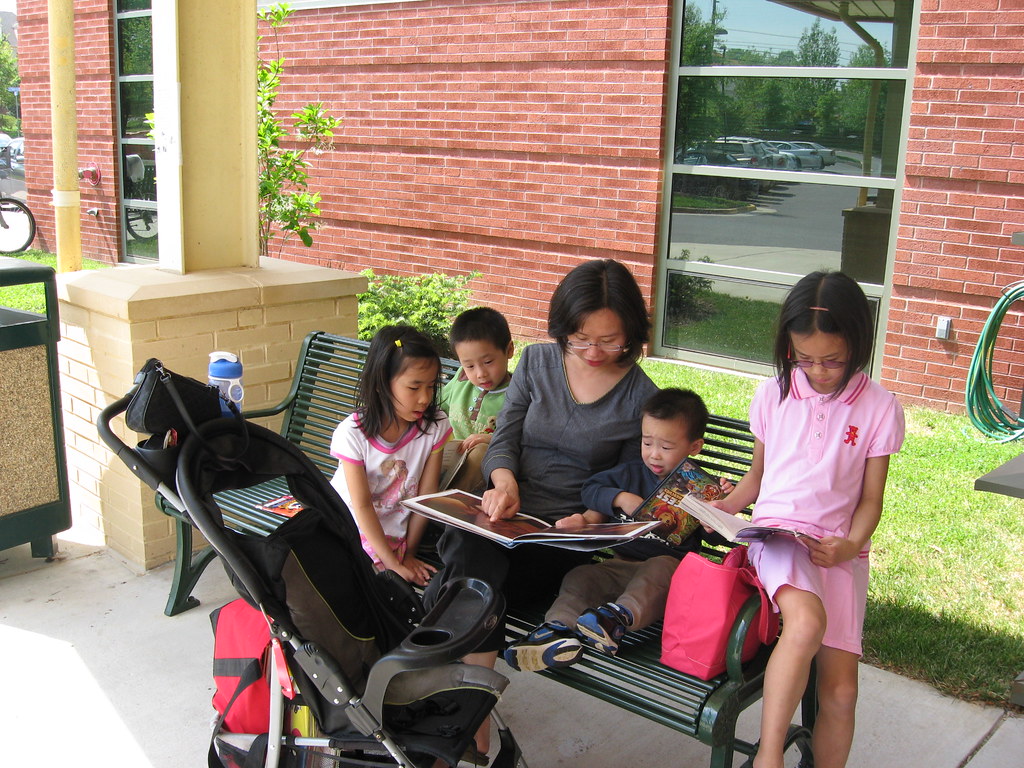 Oakton Library A family enjoyes reading outside. Fairfax County
