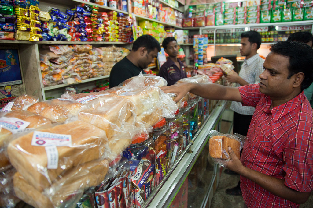 Buying bread in Bangladesh A customer chooses bread in a s… Flickr