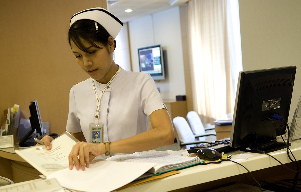 hospital reception desk A nurse at a reception desk at the… Flickr
