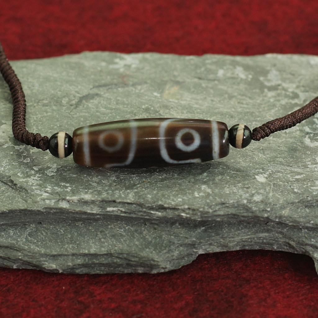 N43 27 The Tibetan "dzi" bead, a type of agate, is susp… Flickr