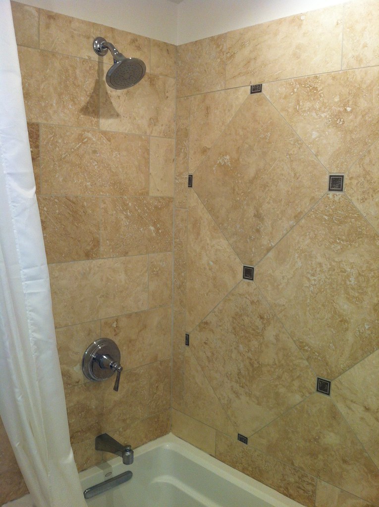 Fairbrook Travertine tile shower/tub. Rain shower head. Waverly