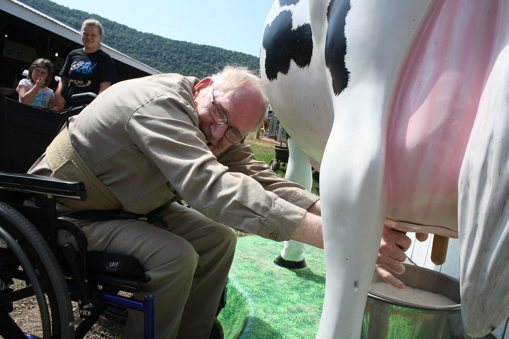 Pepper demonstrating how to milk a cow The Arc of Delaware County