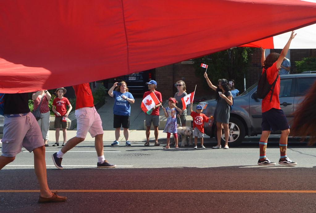 under the Canadian flag watching the parade, Woodbine Ave.… Flickr