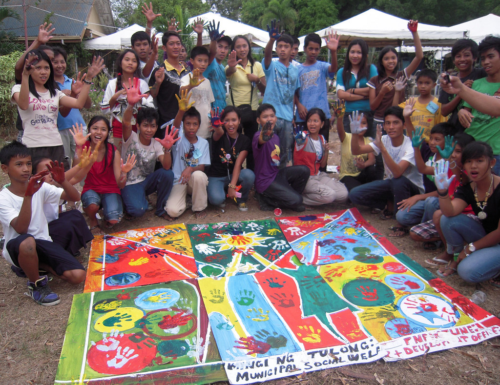 A group of youth peer educators show off their mural Flickr